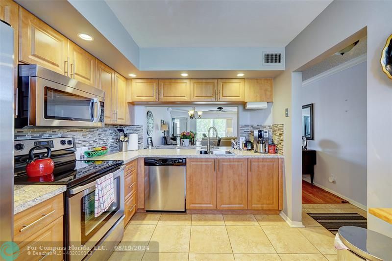 a kitchen with stainless steel appliances granite countertop a stove and a sink