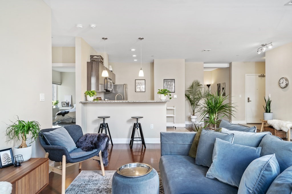 a living room with furniture and a wooden floor