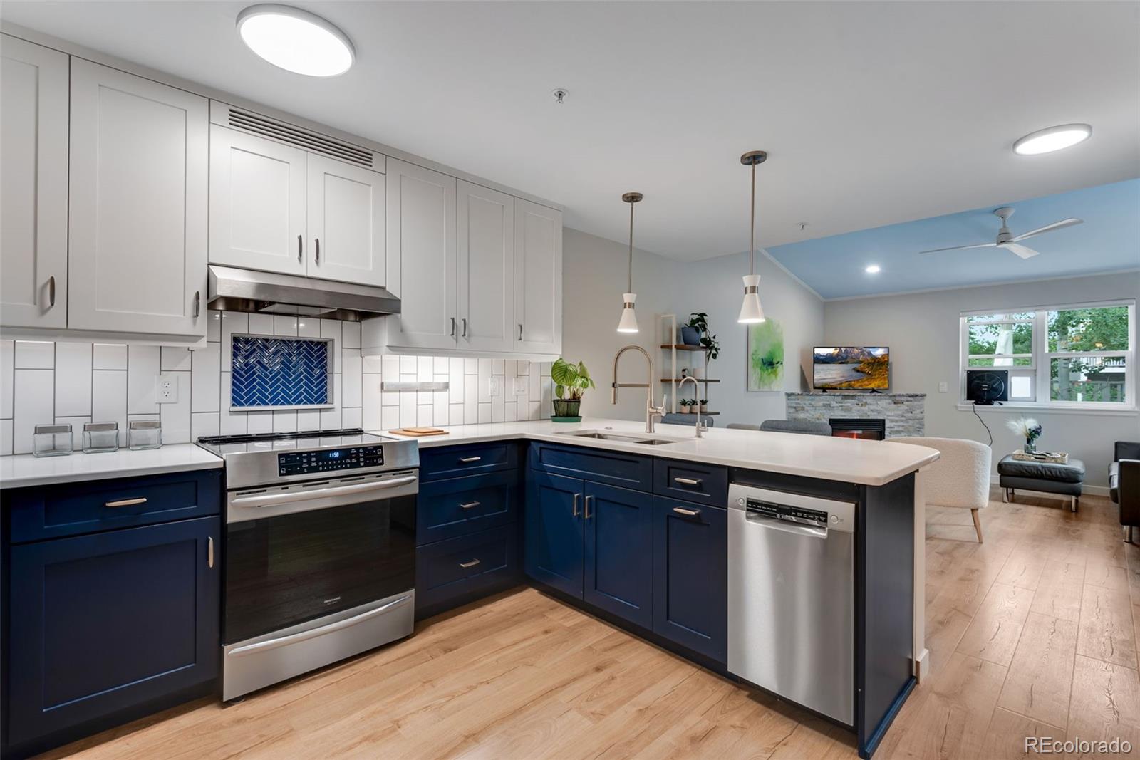 a kitchen with a sink stove and cabinets