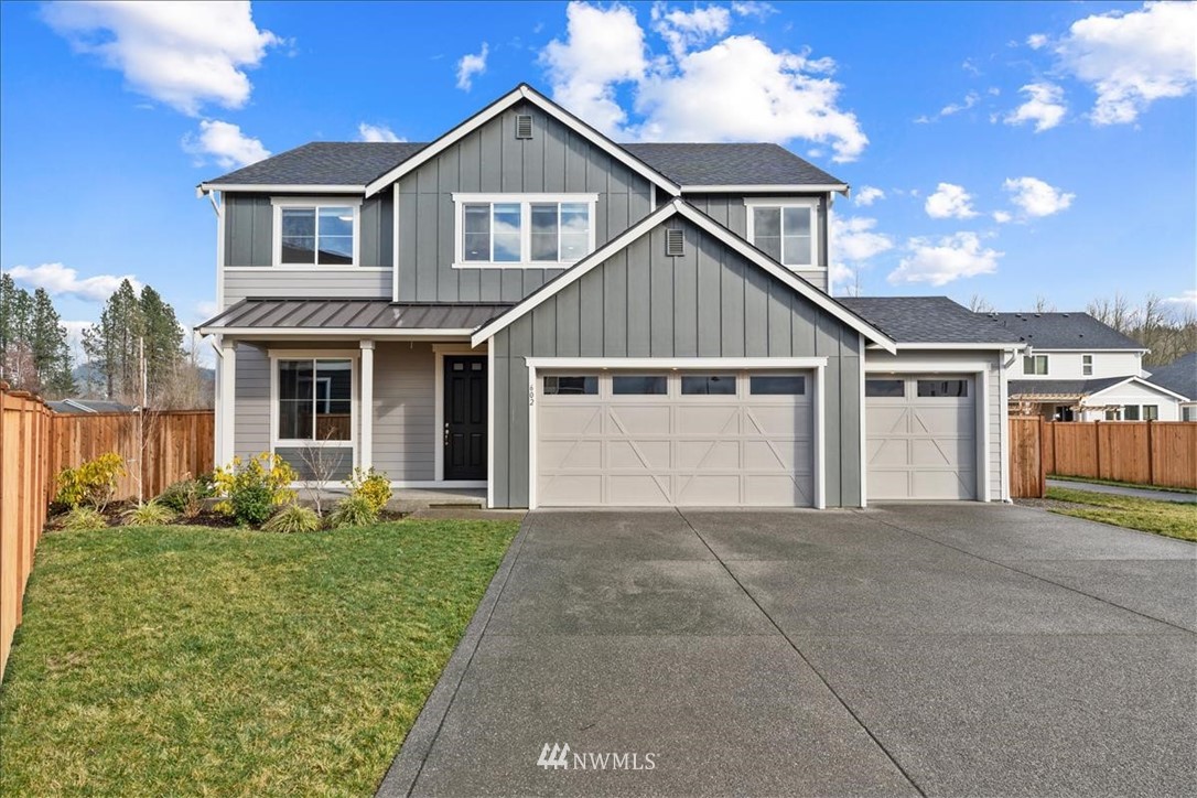 a front view of a house with a yard and garage