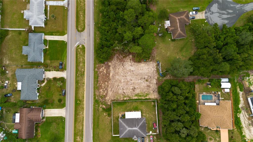 an aerial view of a residential houses with outdoor space