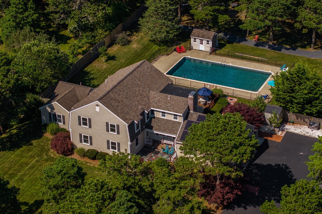 an aerial view of a house with garden space and street view