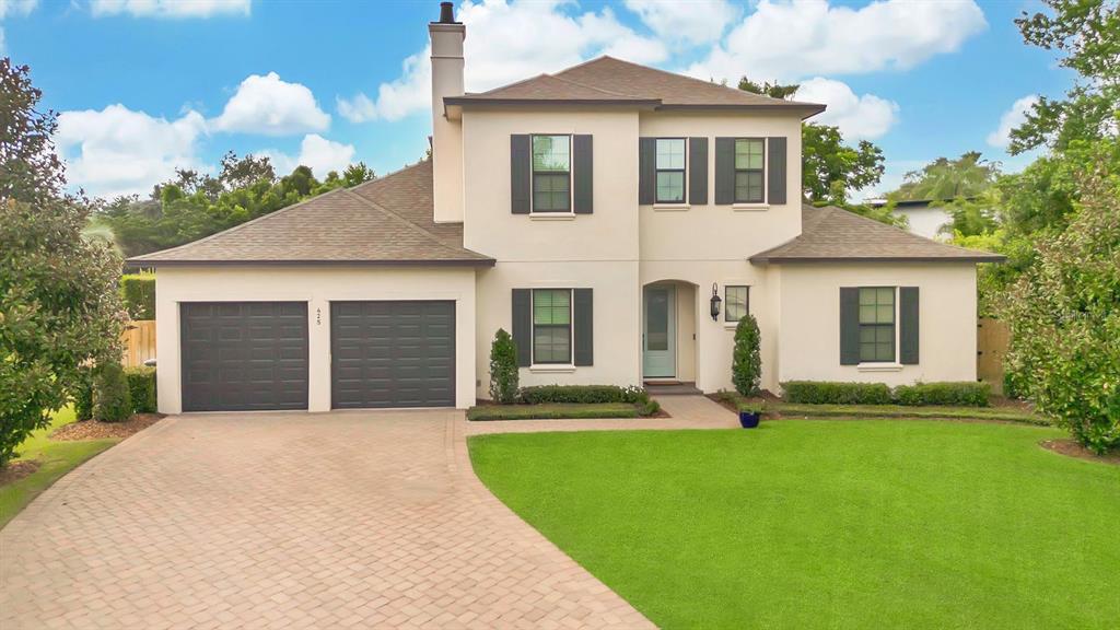 a front view of a house with a yard and garage