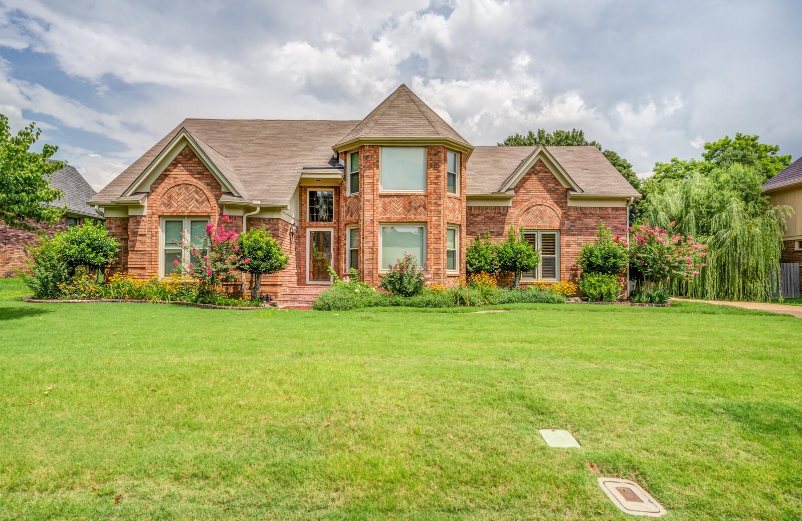 a front view of house with yard and green space