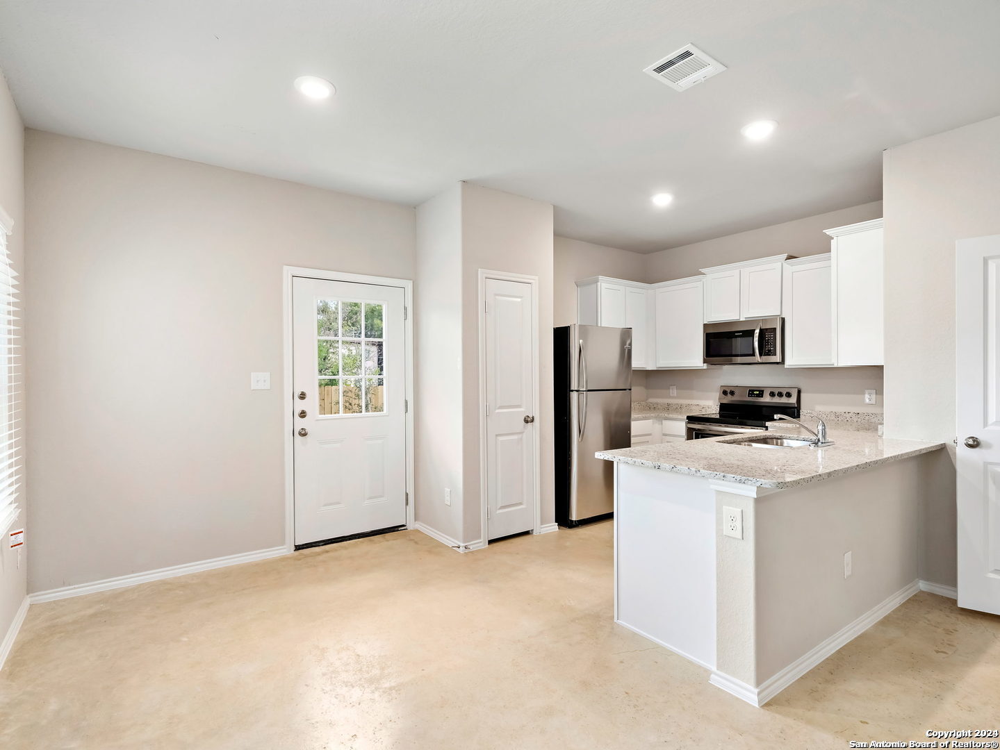 a kitchen with stainless steel appliances a refrigerator stove microwave and sink