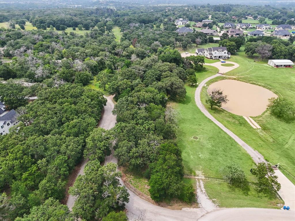 an aerial view of a house with a yard and lake view