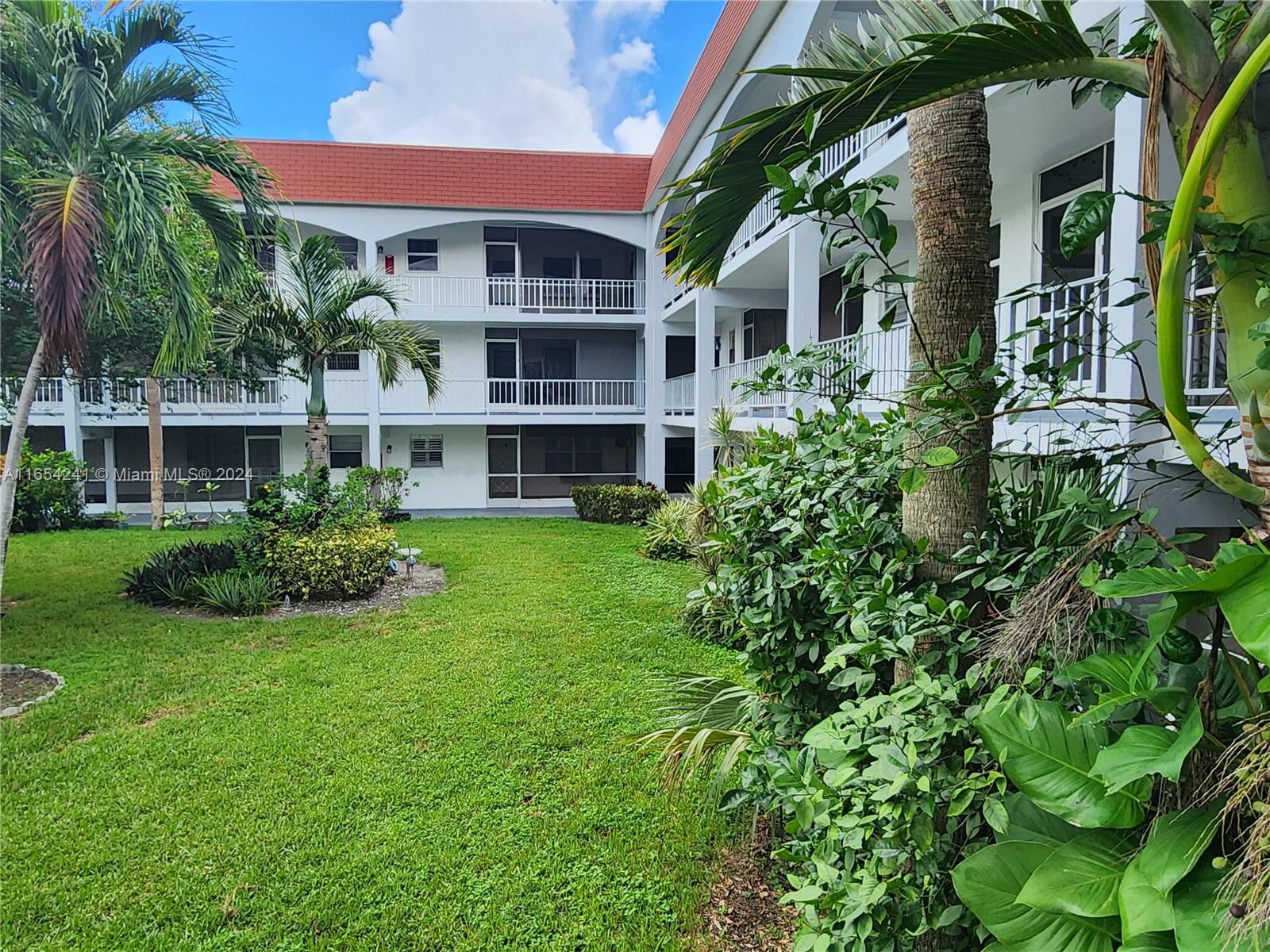 a view of house with yard and green space