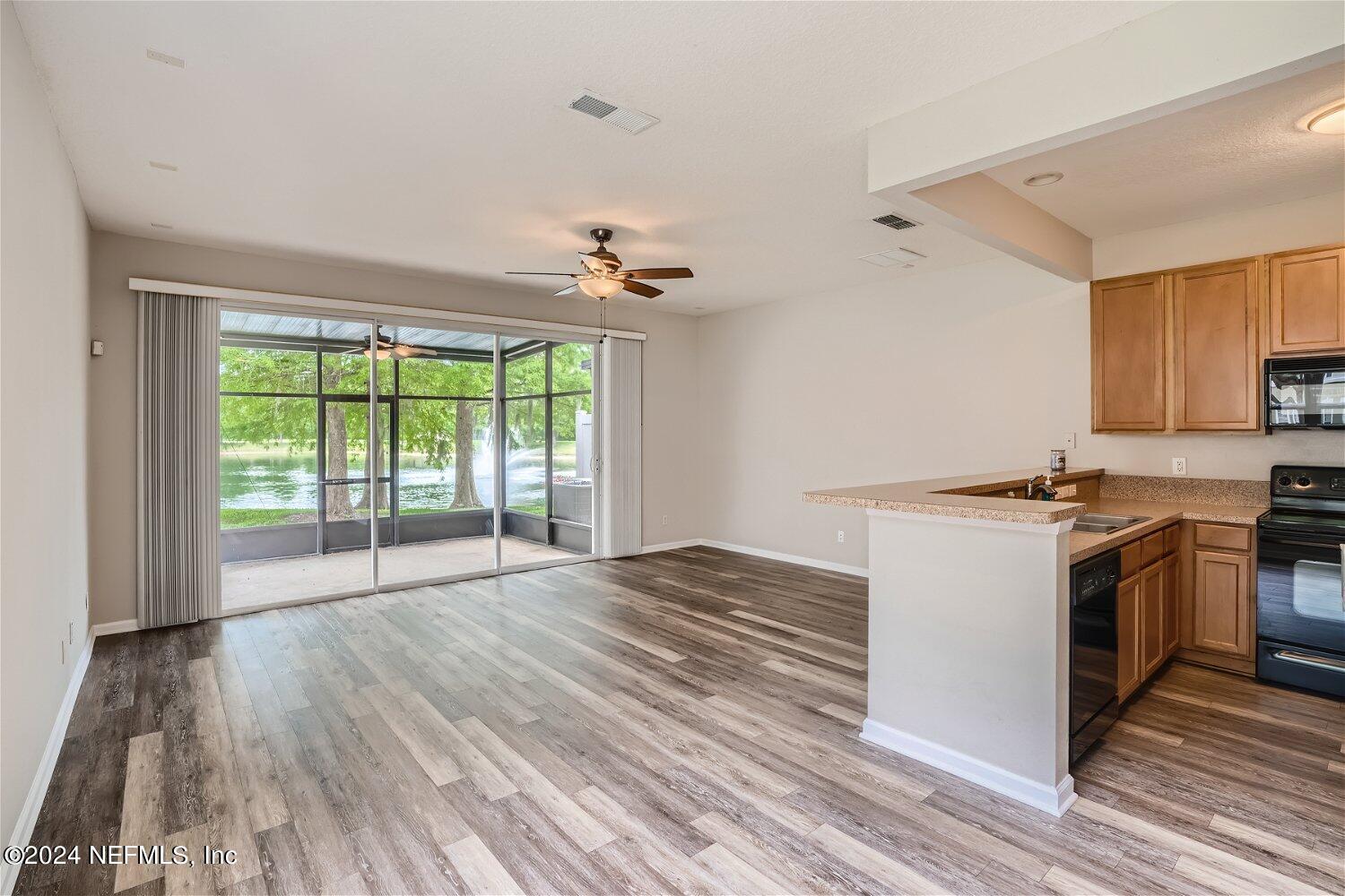 a view of kitchen with stove and wooden floor