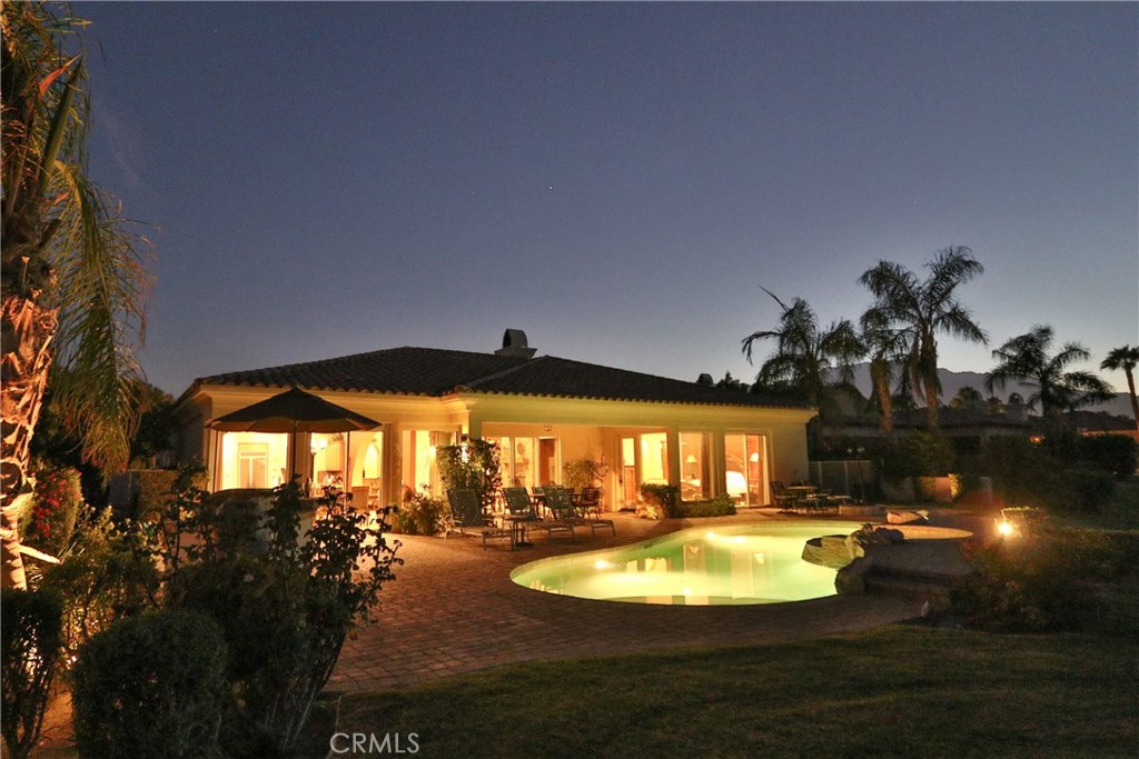 a view of a swimming pool with an outdoor space and seating area