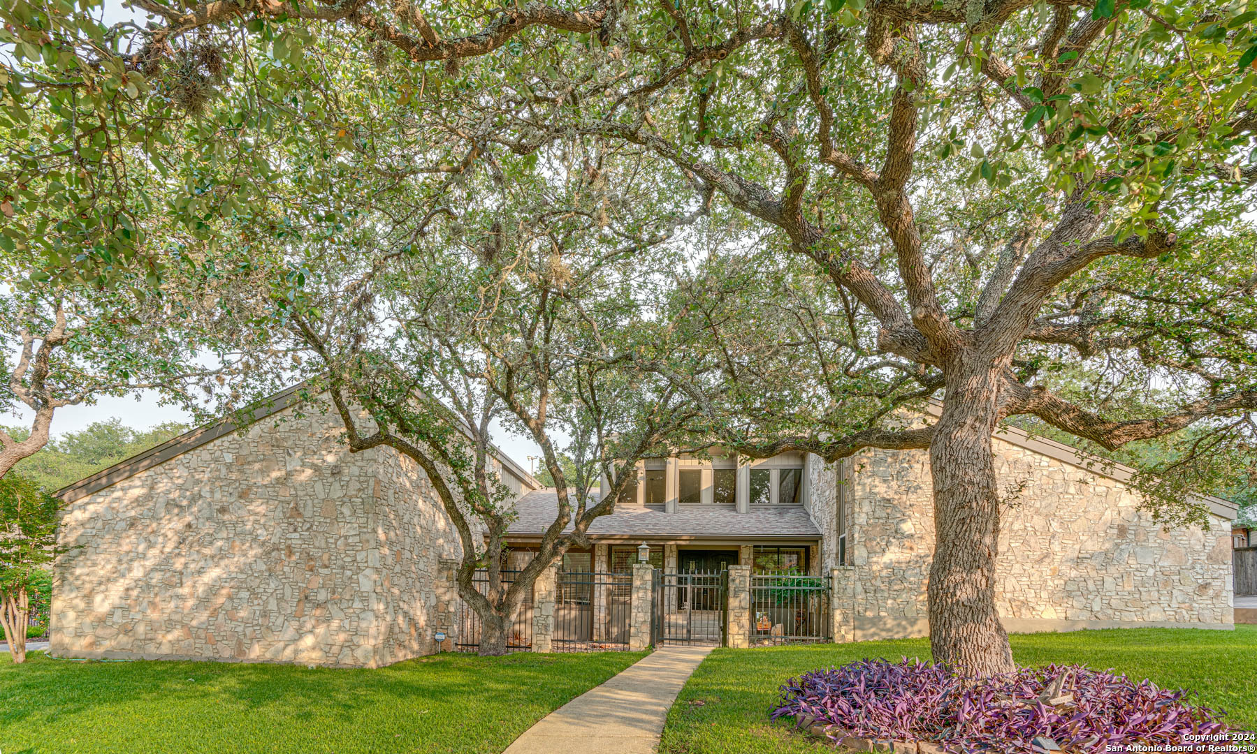 a front view of a house with garden