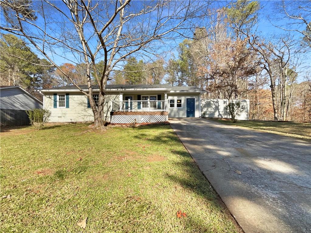 a front view of a house with a yard and trees