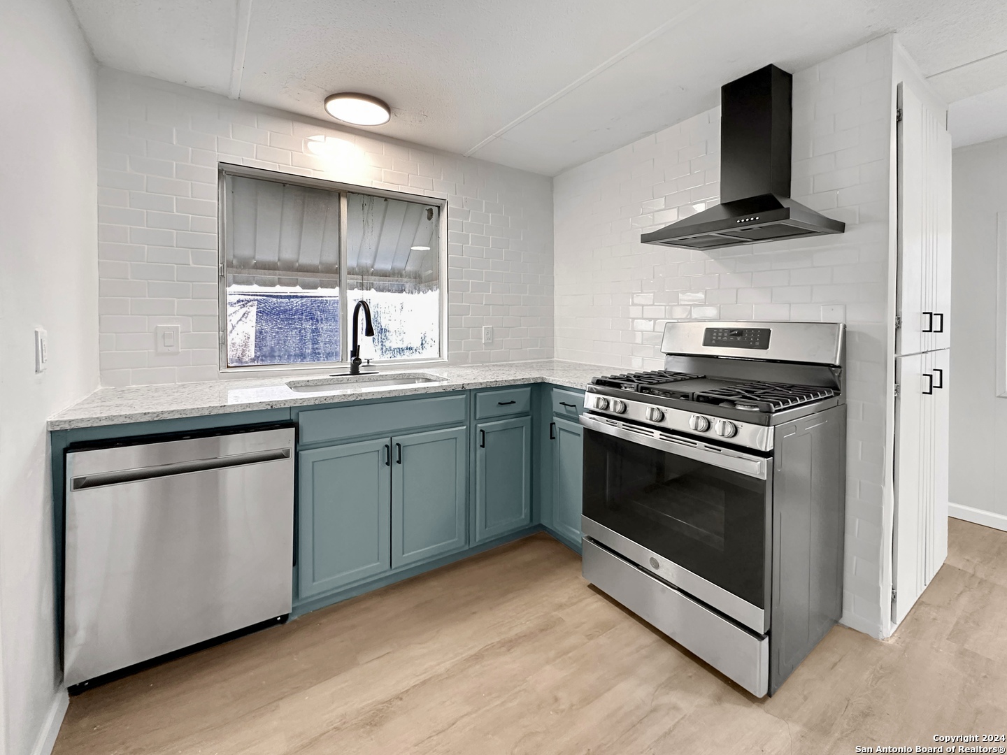 a kitchen with a stove and a sink