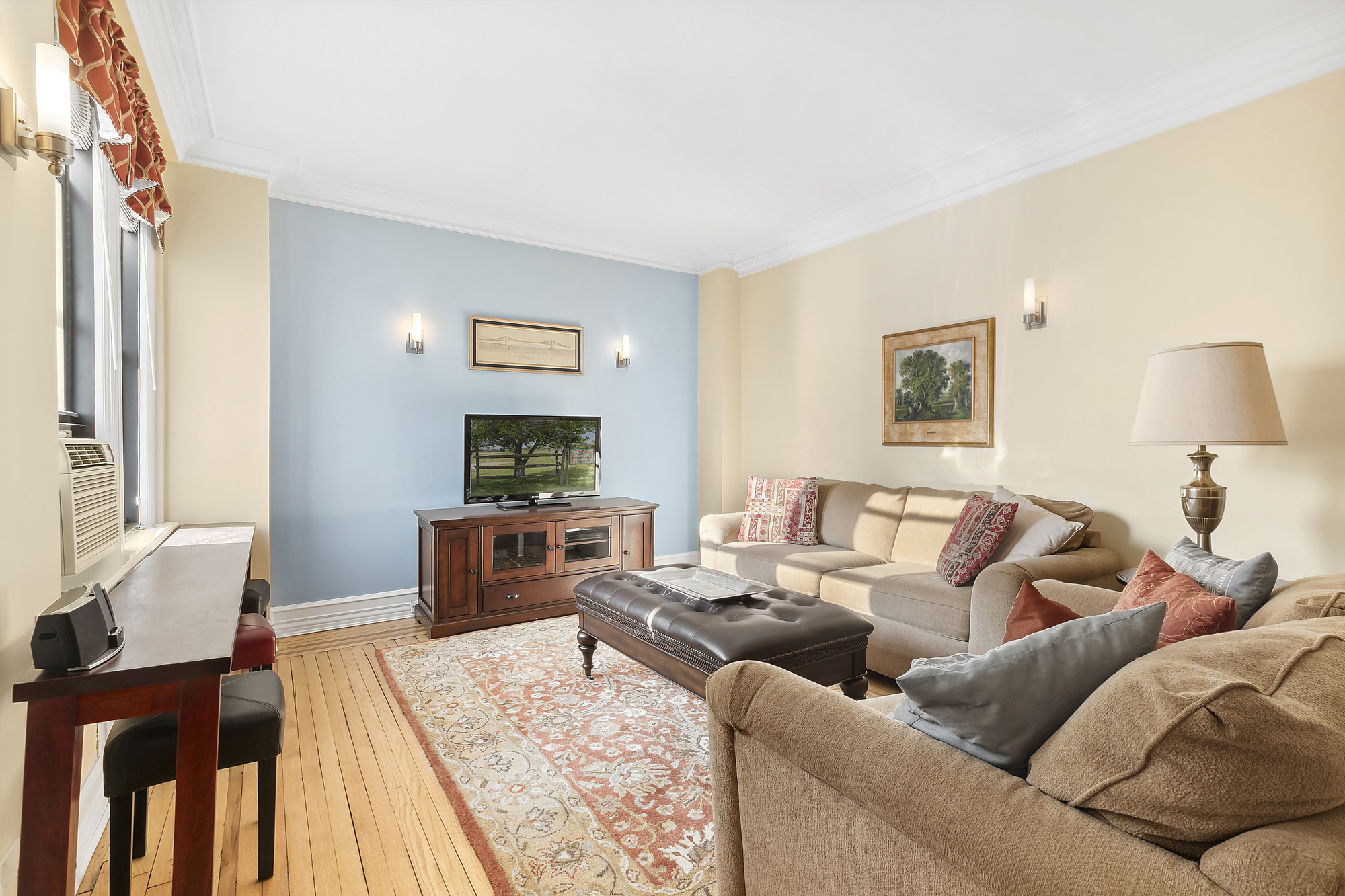 a living room with furniture and a wooden floor