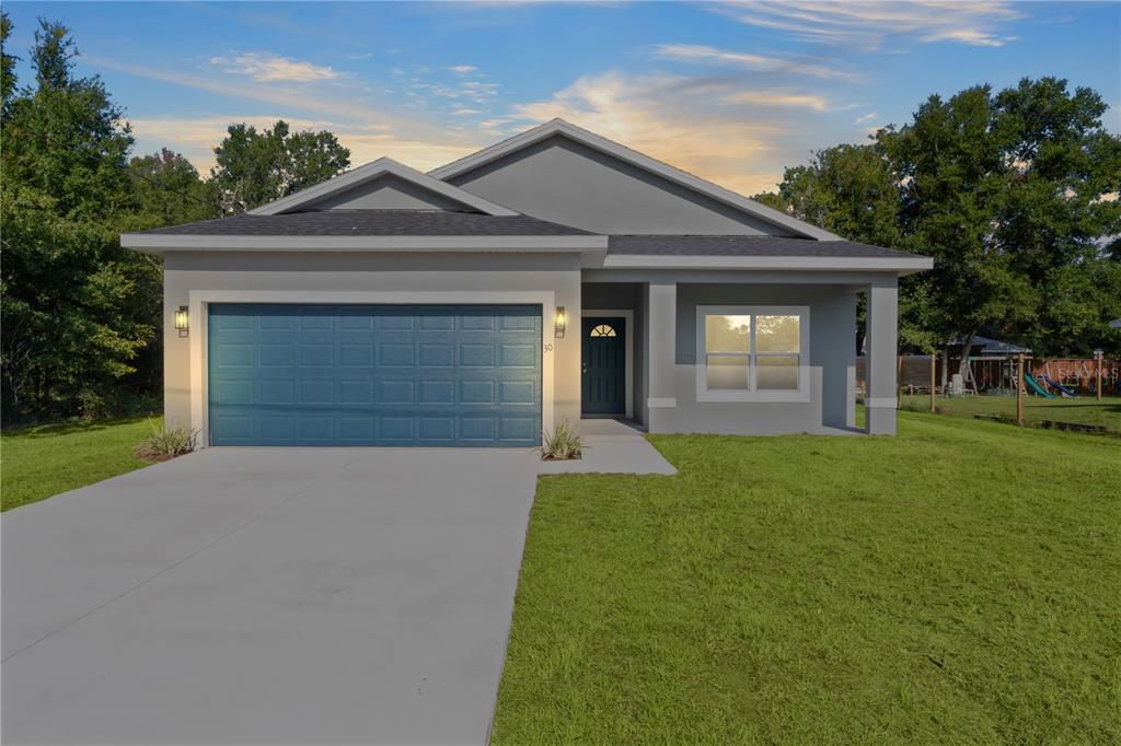 a front view of a house with a yard and garage