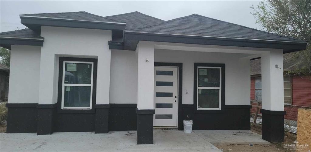 a front view of a house with a black gate