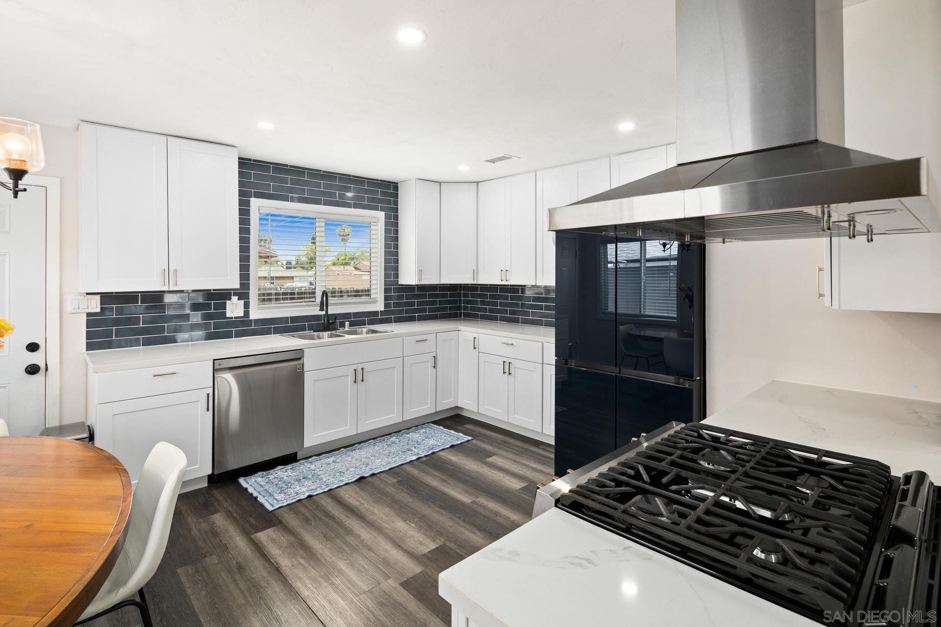 a kitchen with a stove a sink and a refrigerator