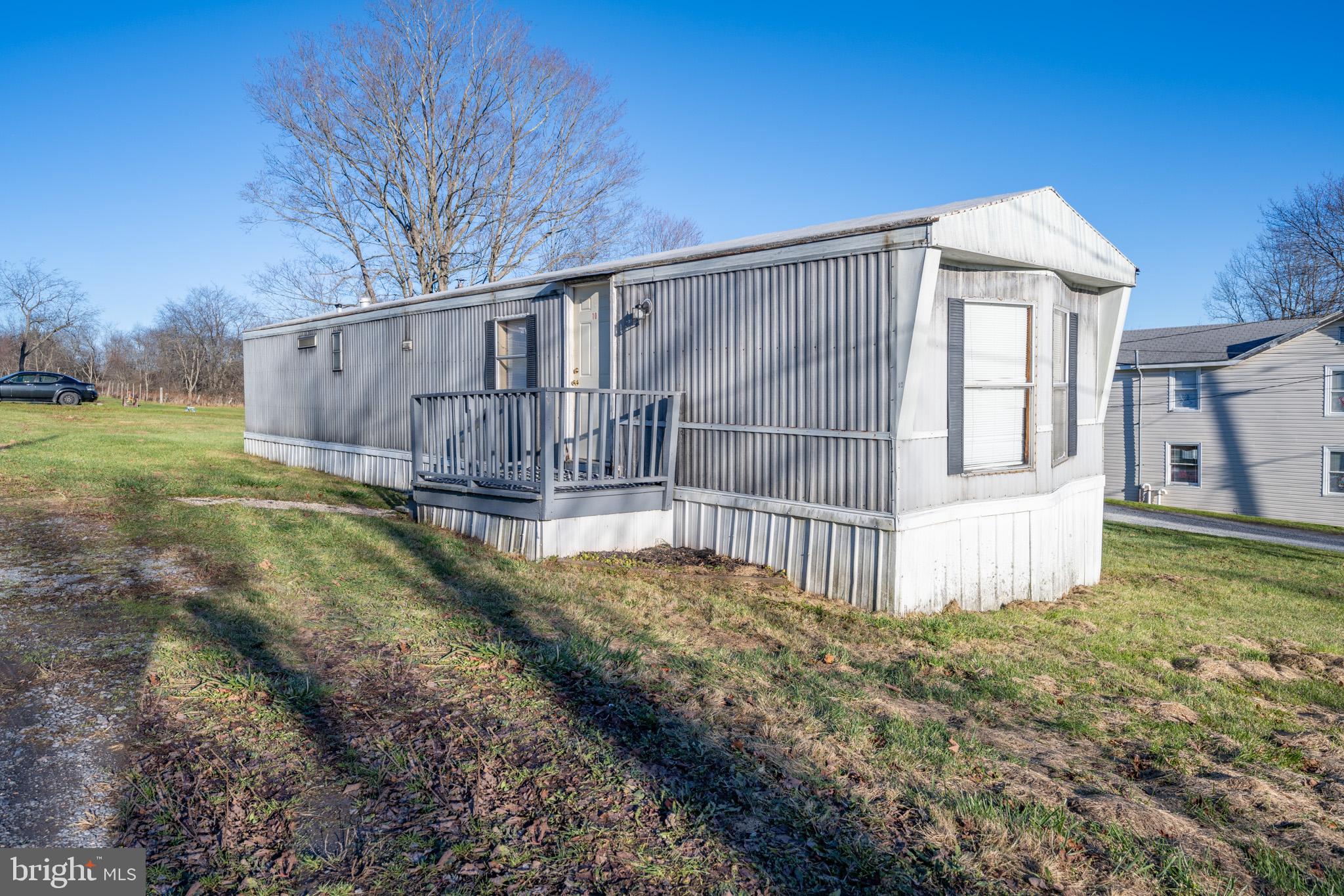 a view of a house with a yard and fence