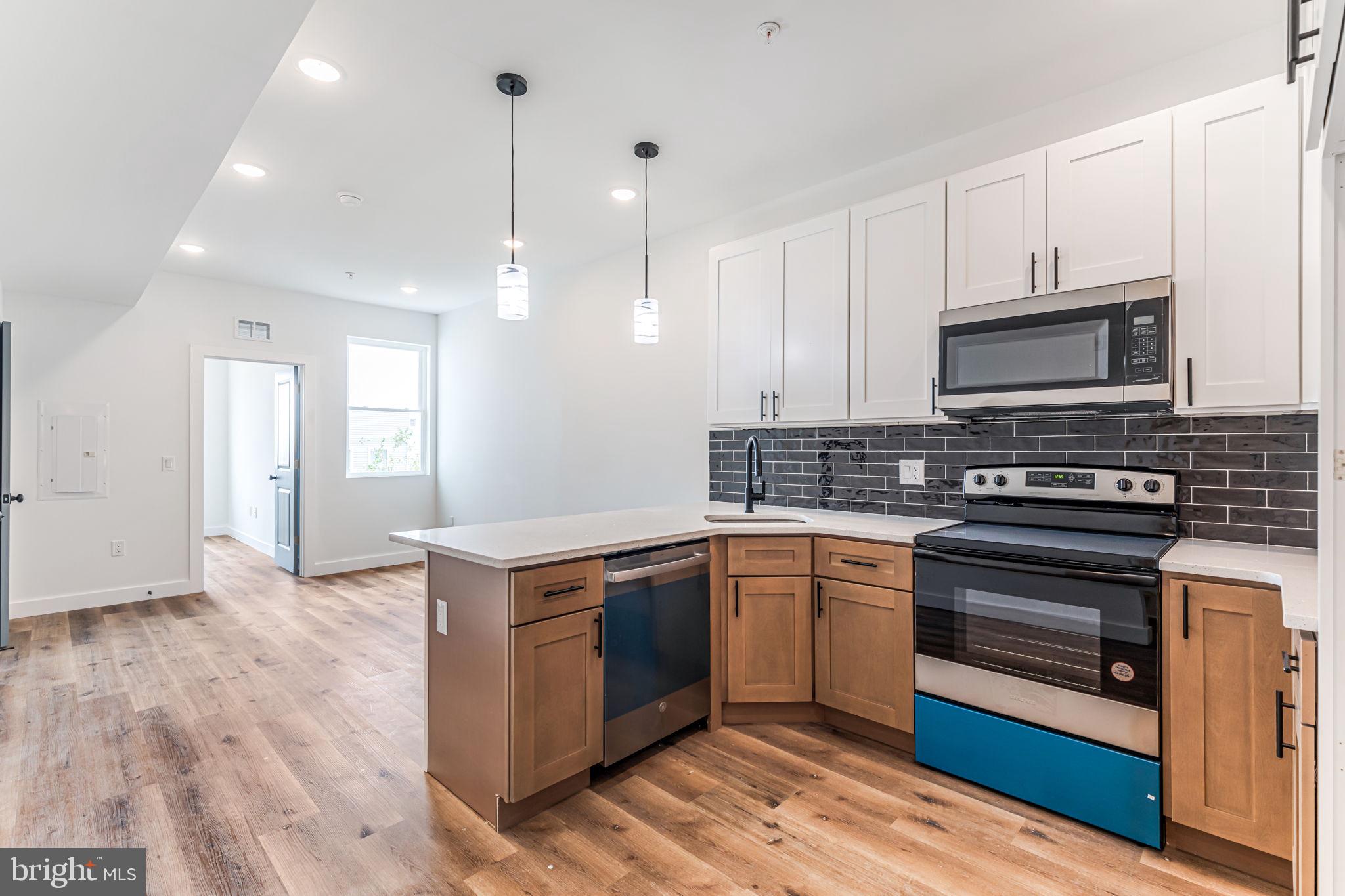 a kitchen with stainless steel appliances granite countertop a stove and a sink