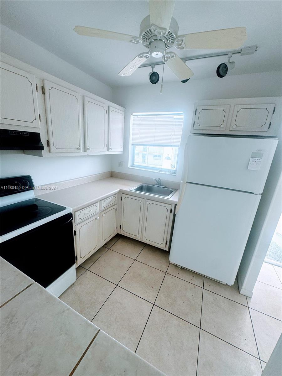 a kitchen with a cabinets a sink and appliances