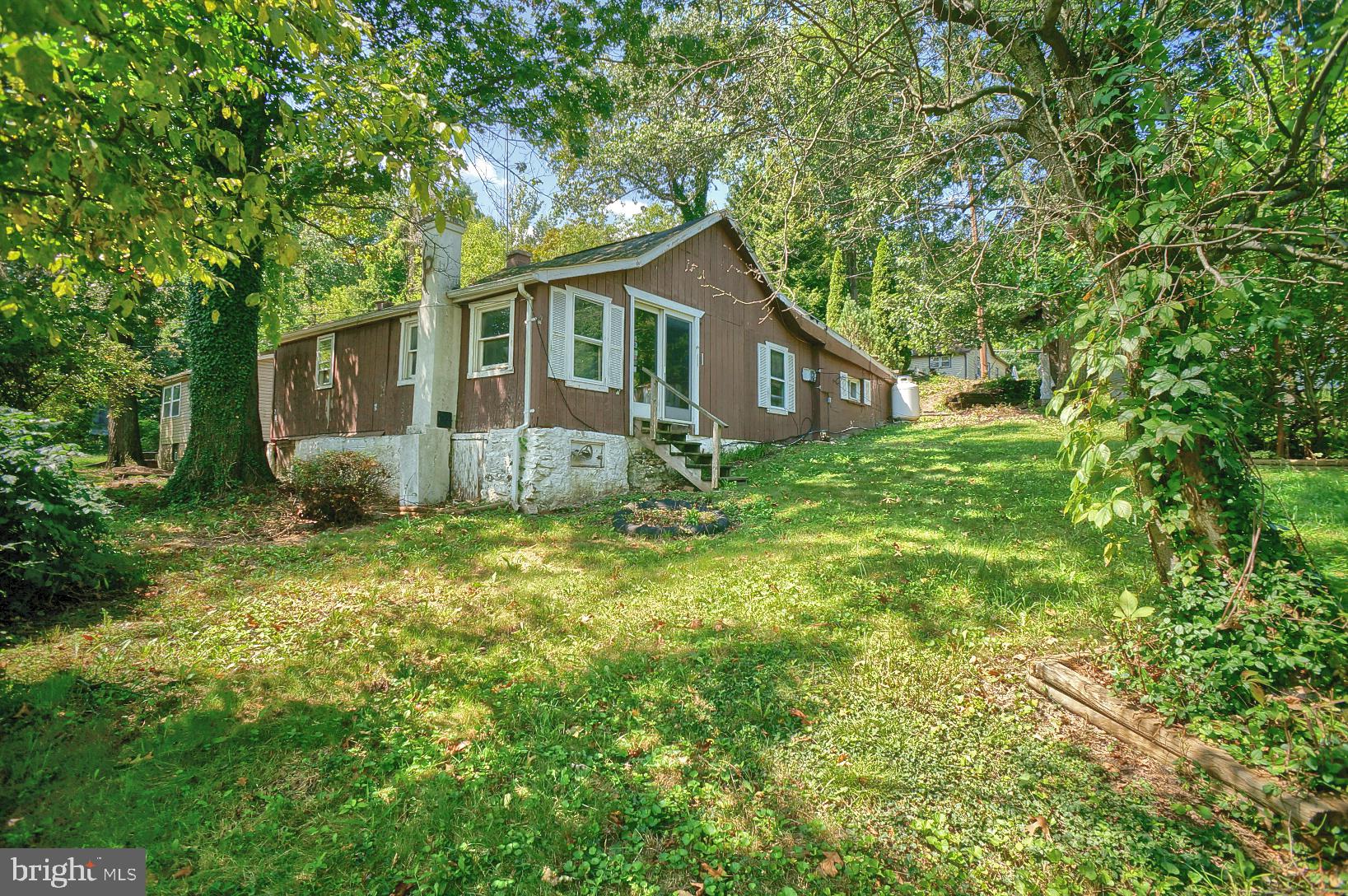 a house is sitting in middle od the grass