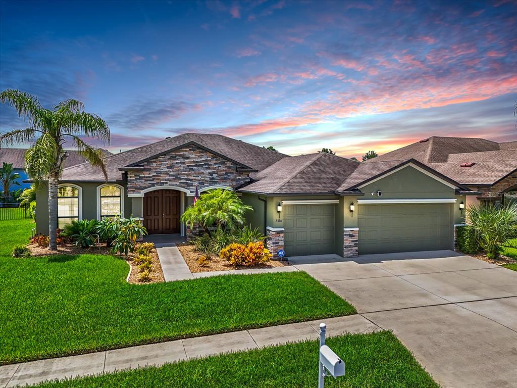 a front view of a house with a garden and a yard