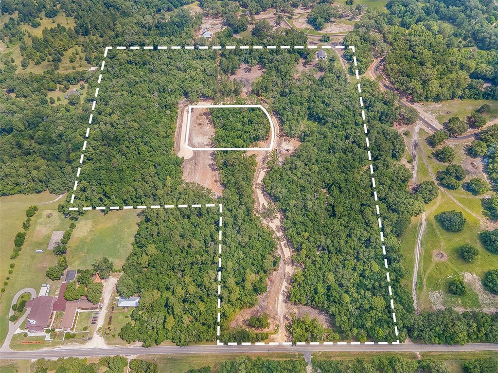 an aerial view of a house with a yard basket ball court