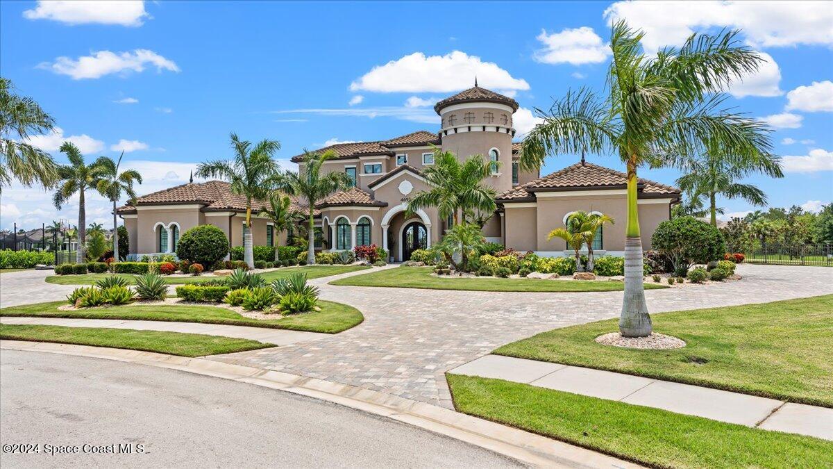 a front view of a house with a yard fountain and a fountain