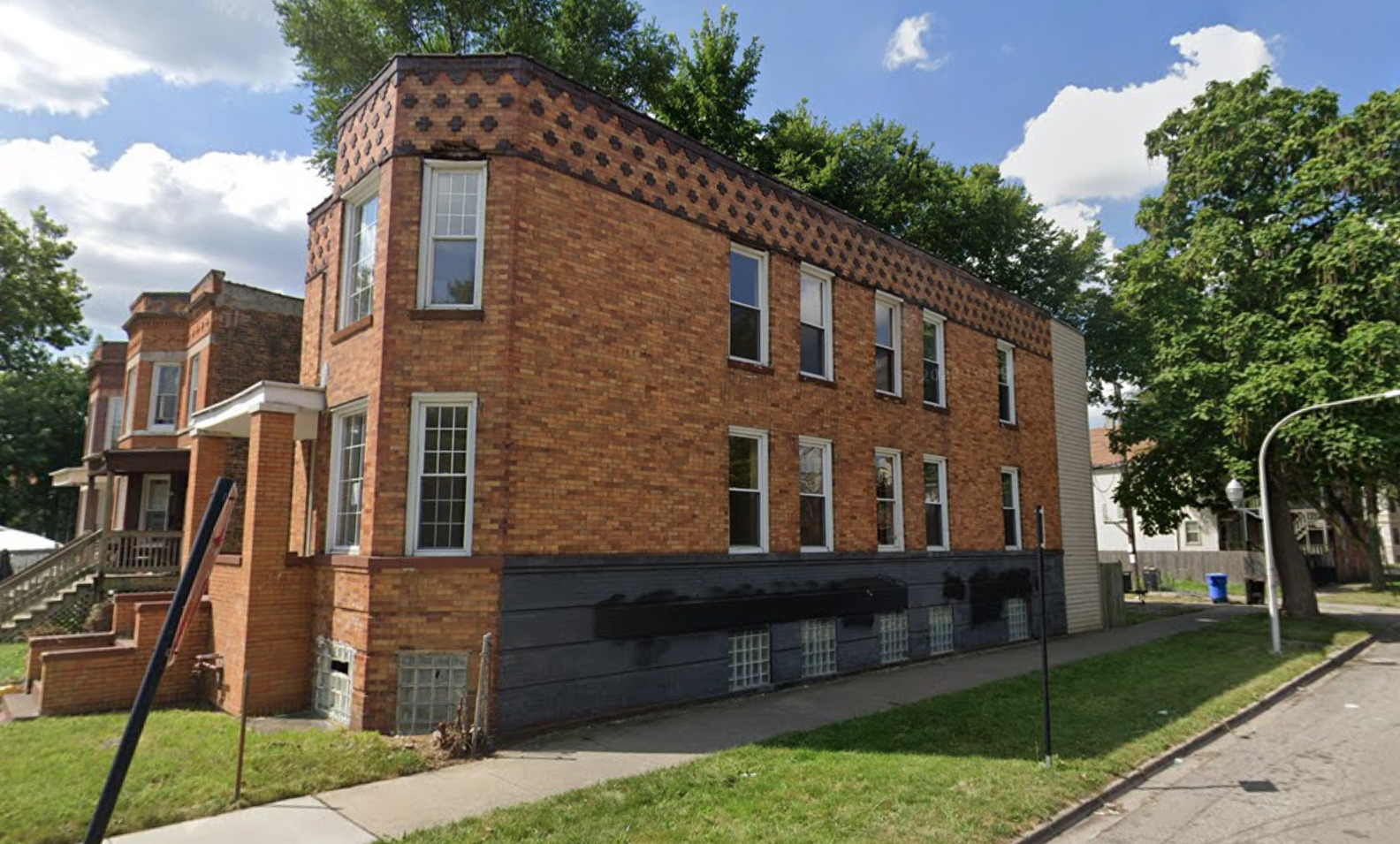 a front view of a house with a garden