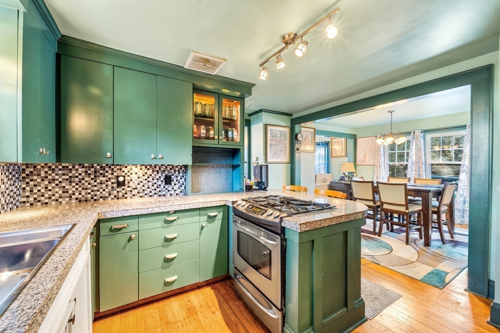 a kitchen that has a stove and a table