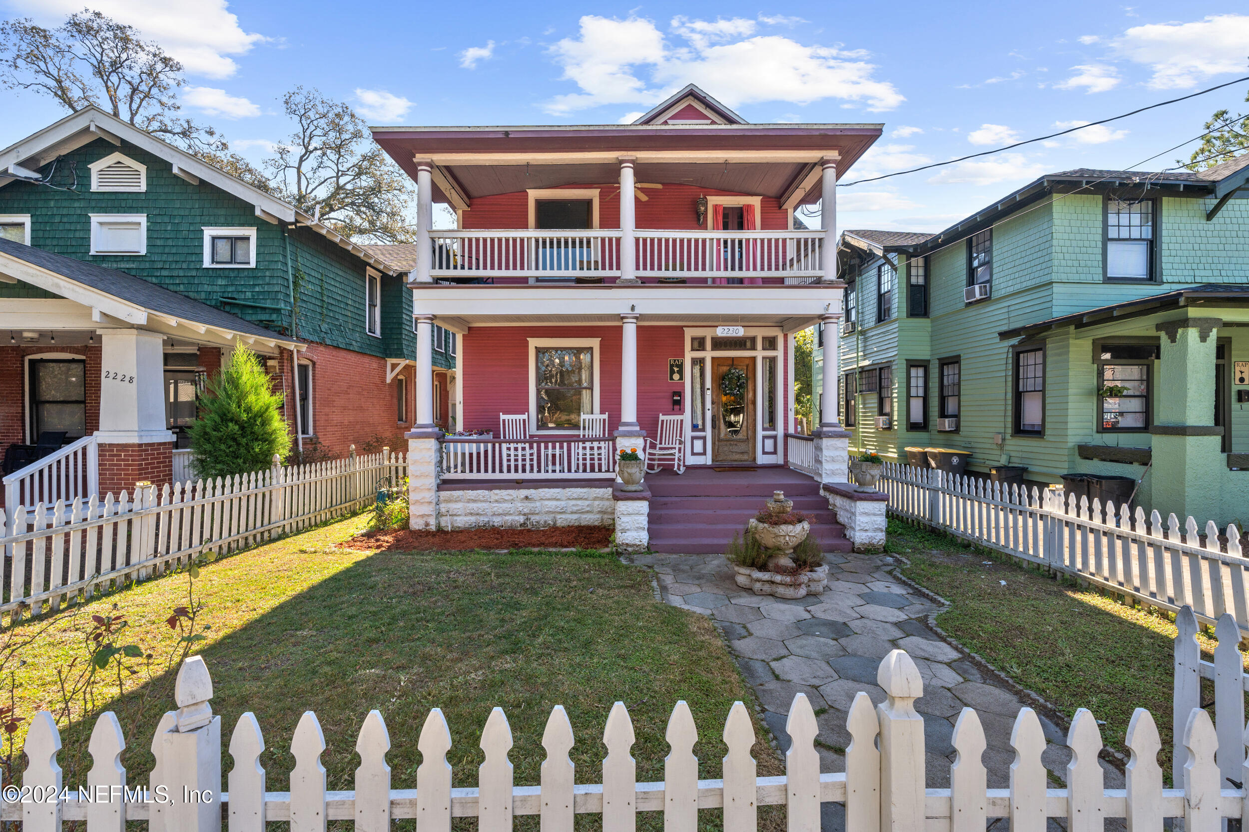 a view of a house with a wooden deck