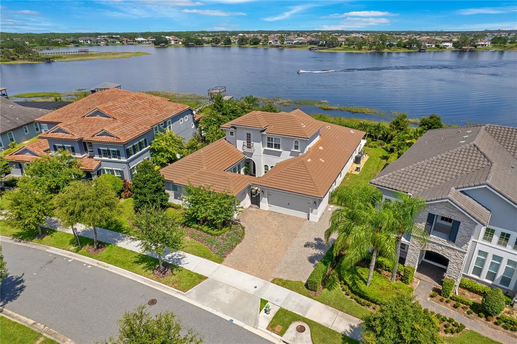 an aerial view of house with yard and lake view