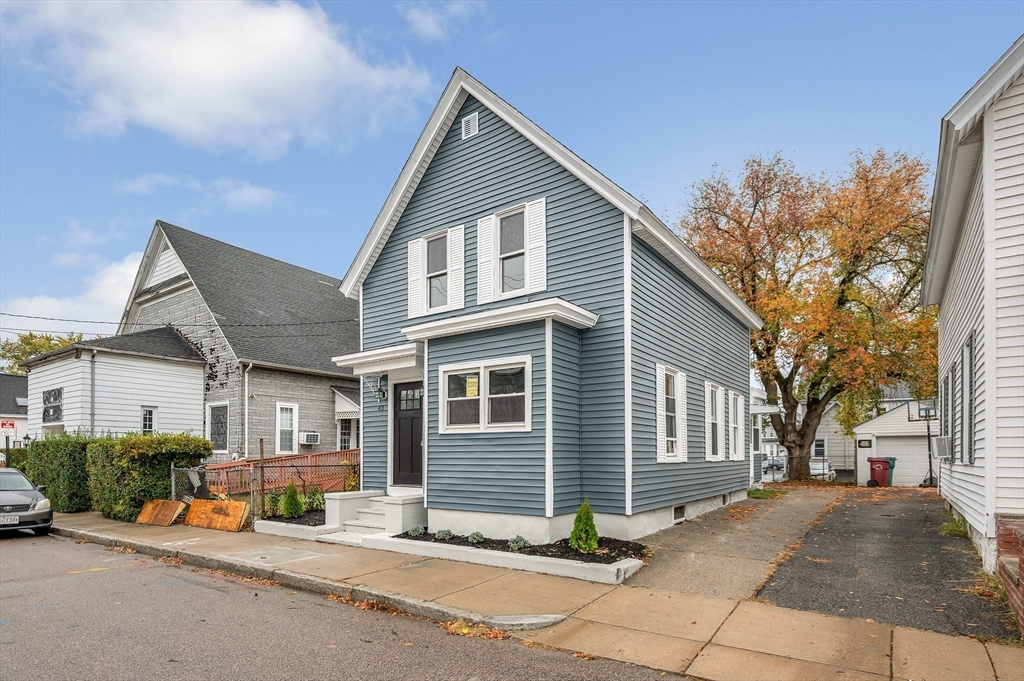 a view of a house with outdoor space and parking area