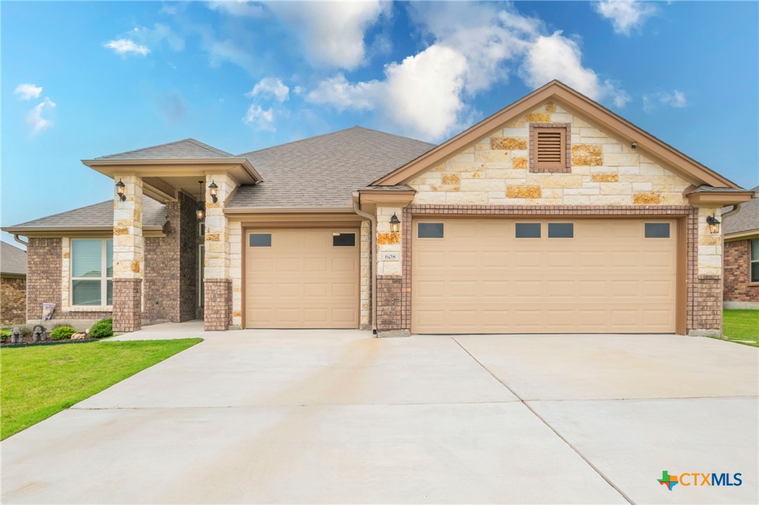 a front view of a house with a yard and garage