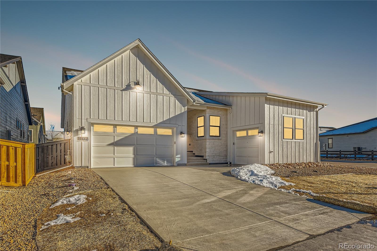 a view of a house with backyard and parking