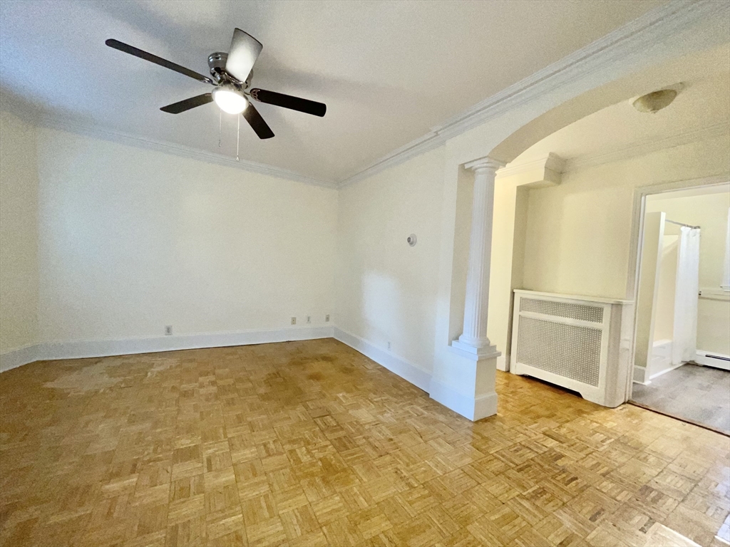 an empty room with closet and windows