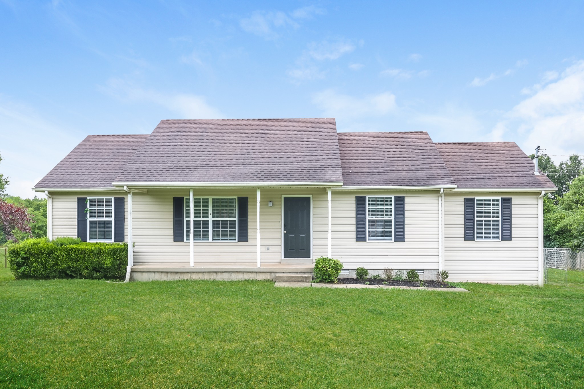 a front view of a house with a garden