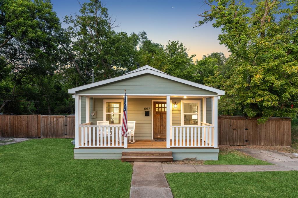 a front view of a house with a yard and fence