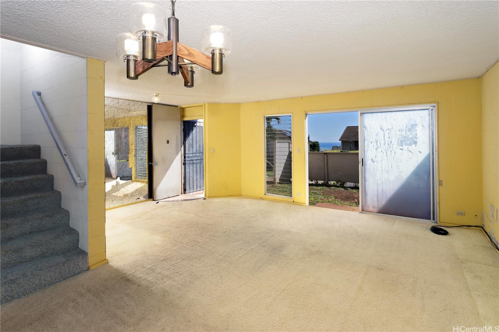 Welcome home to a large living room. Note the enclosed yard area just outside the sliding door.