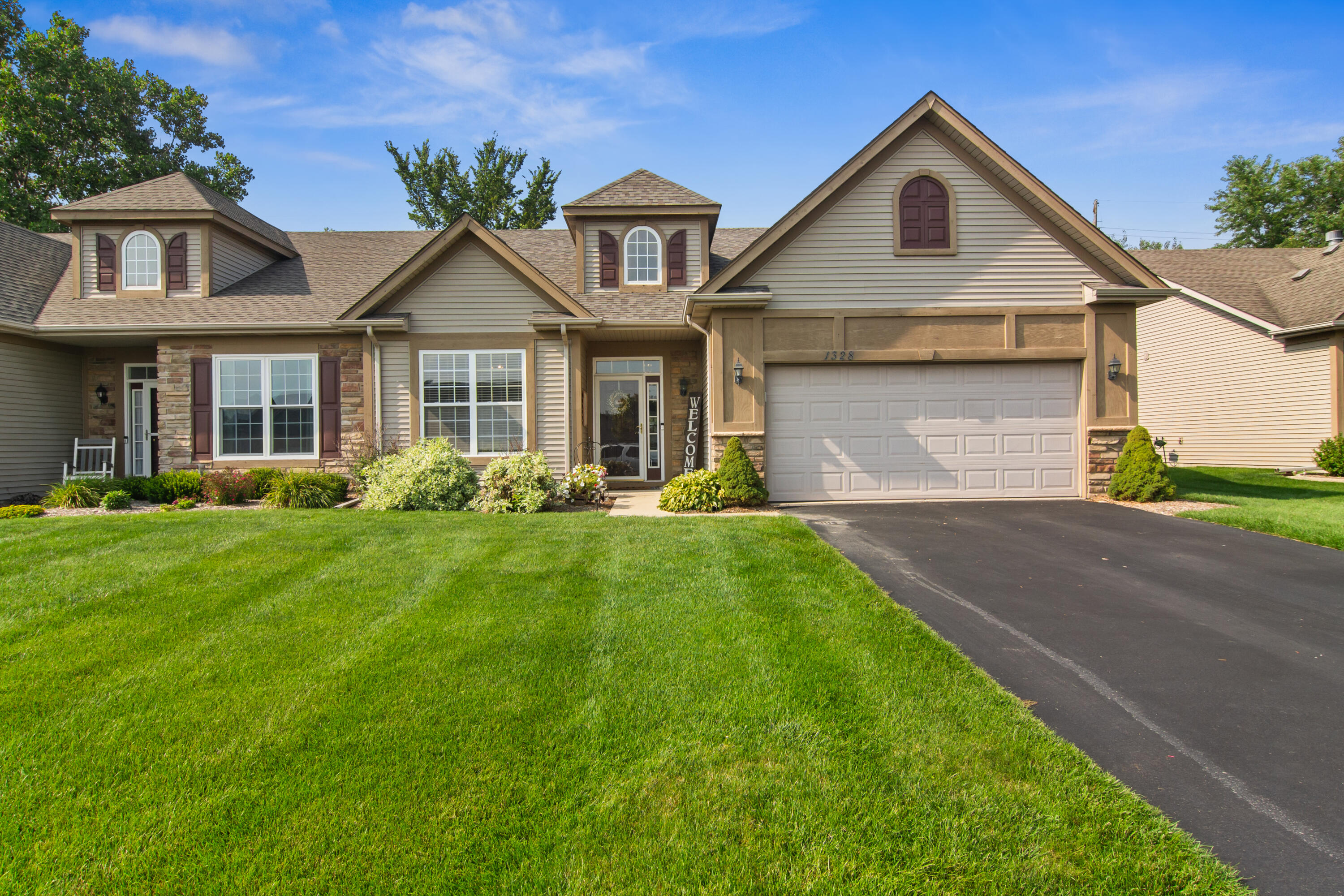 a front view of a house with a yard and garage