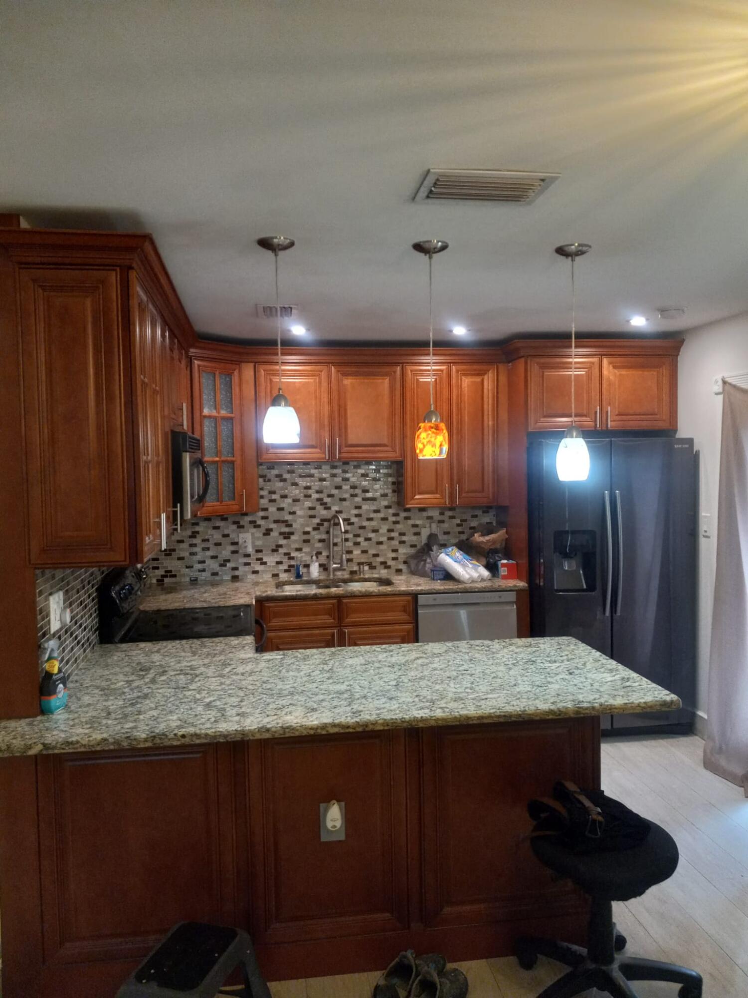 a bathroom with a granite countertop sink a toilet and a large mirror