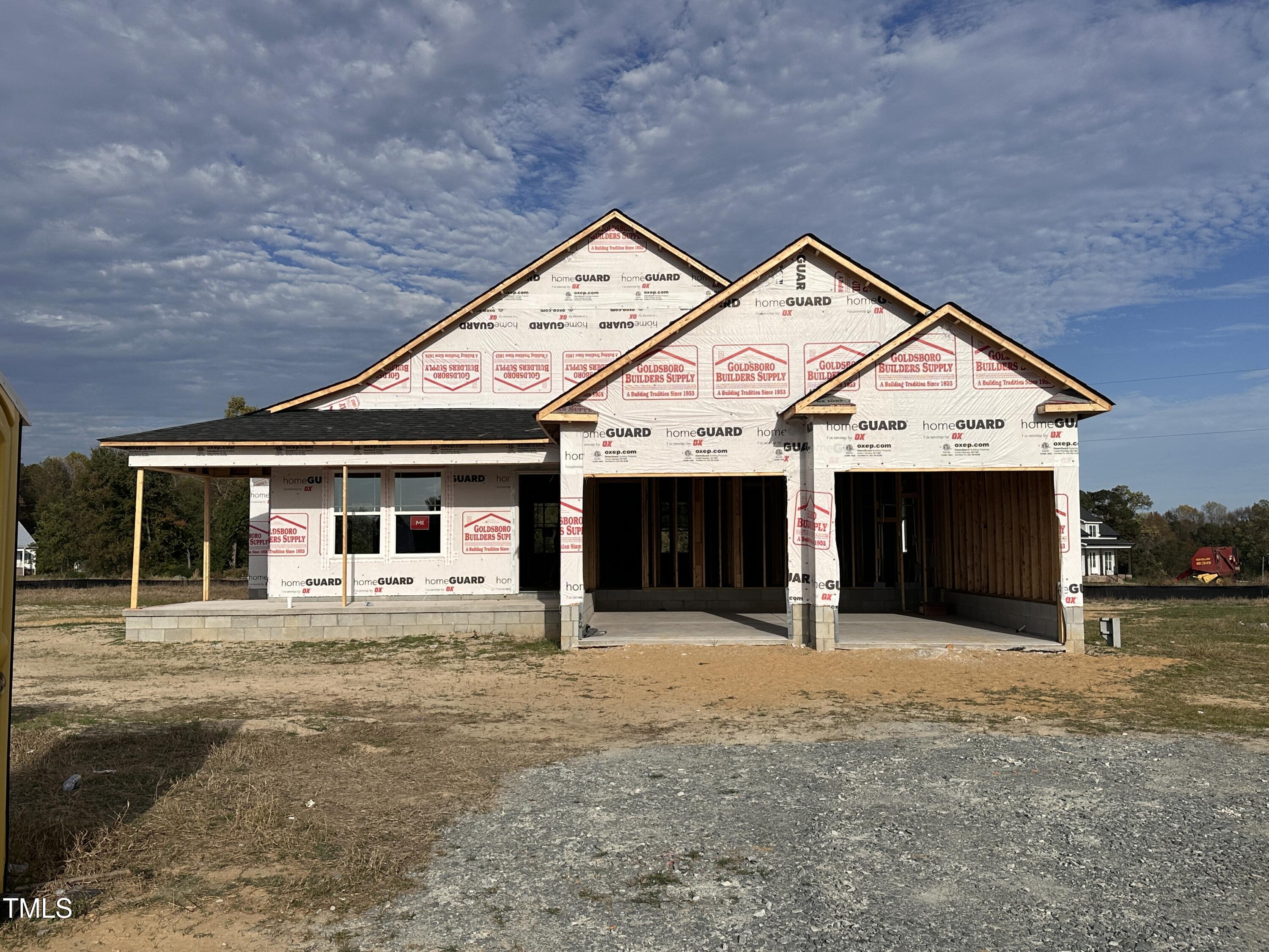 a front view of a house with yard and garage