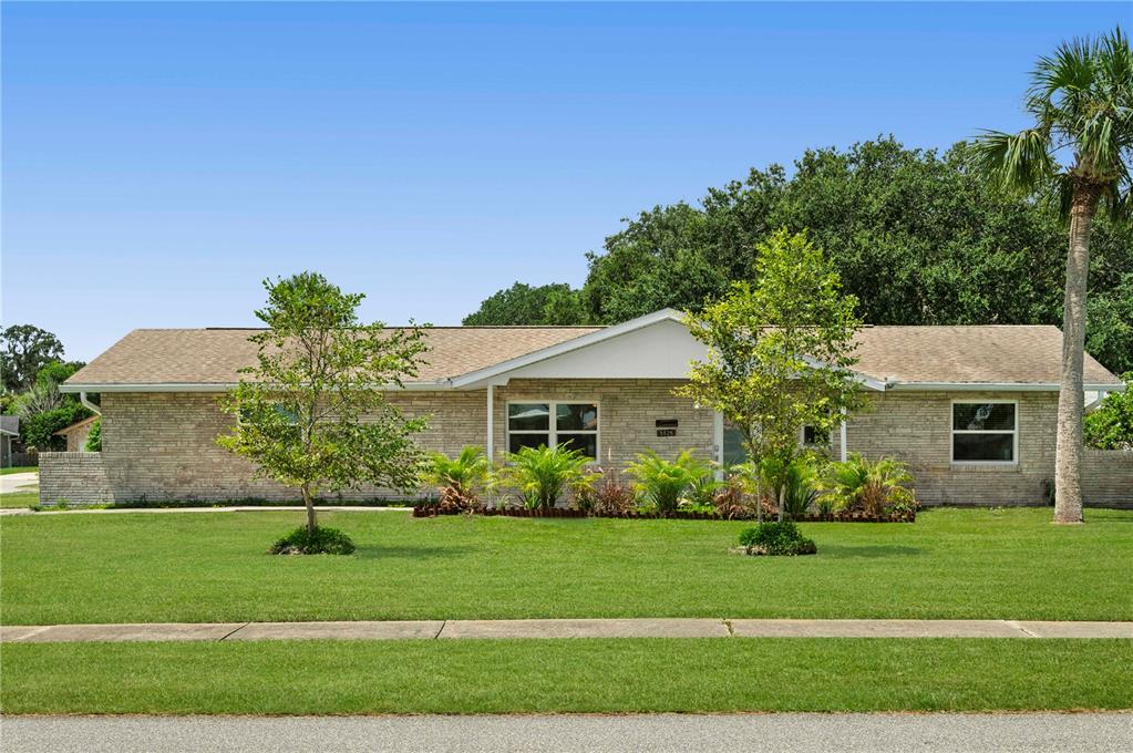 a front view of house with yard and green space