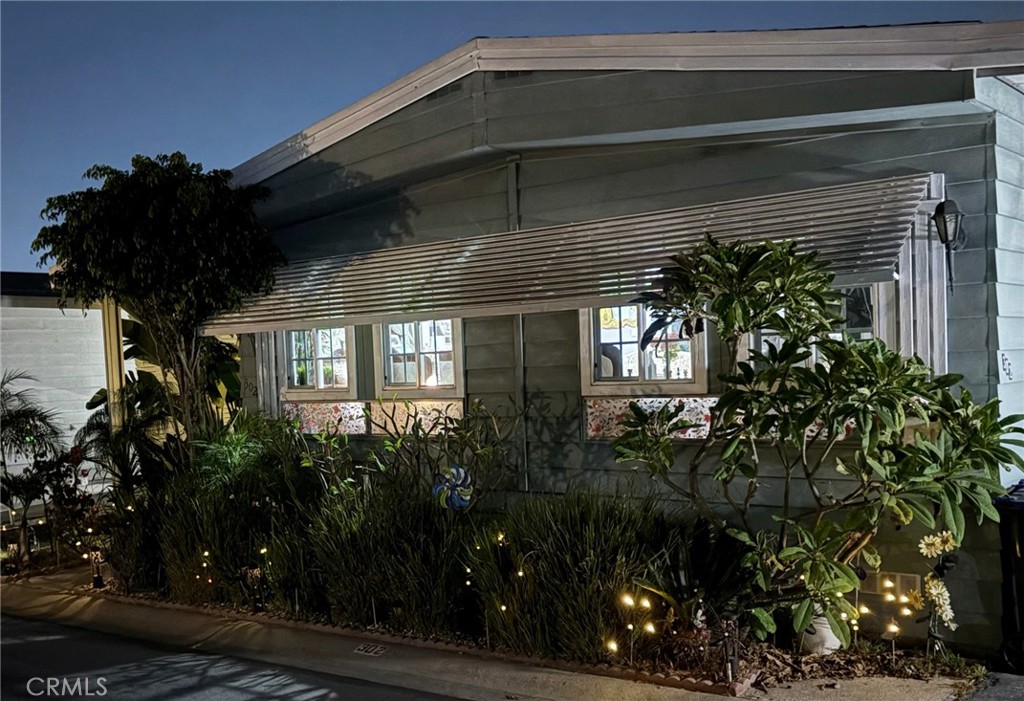 a front view of a house with plants