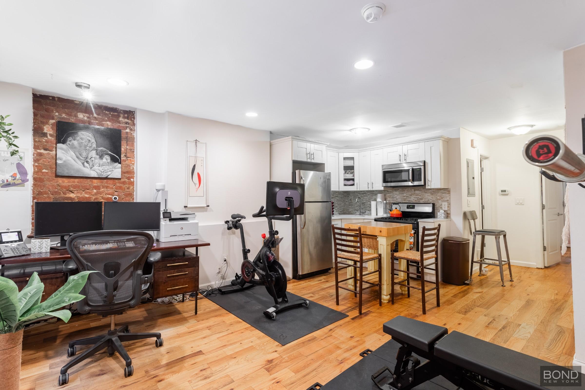 a view of a workspace with furniture and a flat screen tv