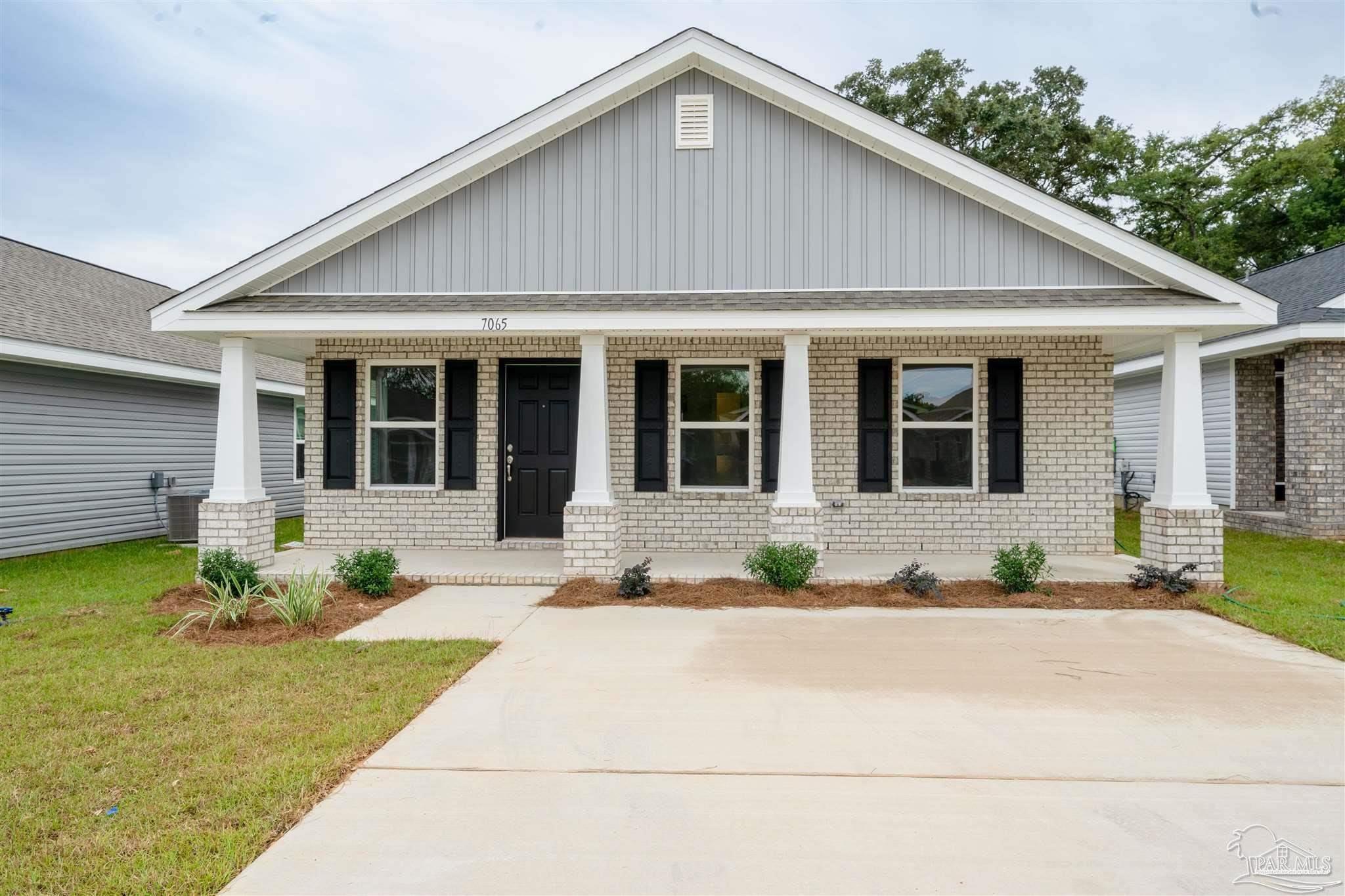 a front view of a house with a garden and entryway