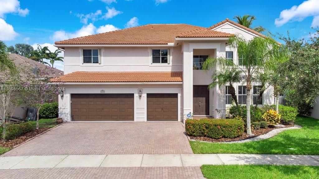 a front view of a house with a yard and garage