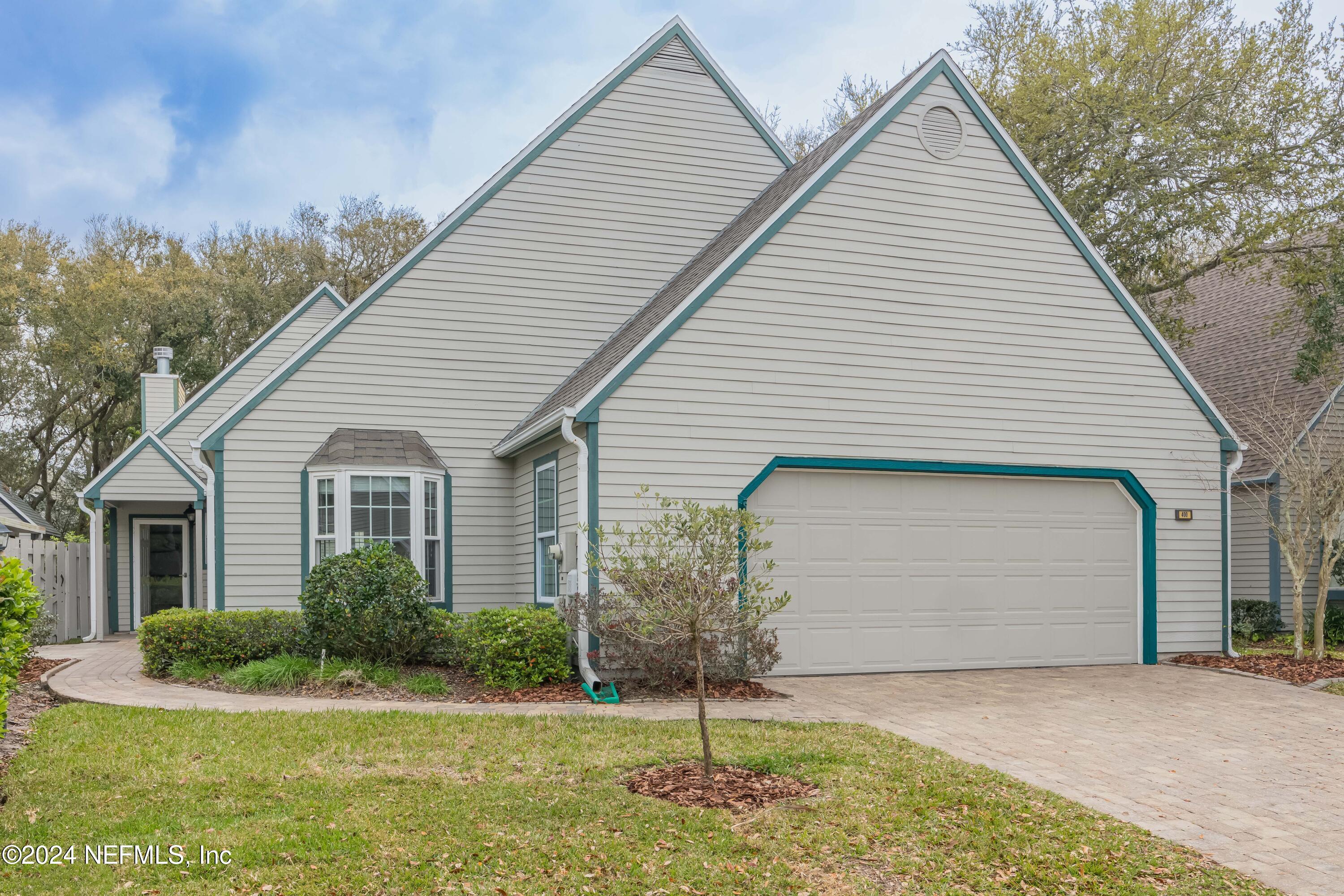 a view of a house with a yard and garage