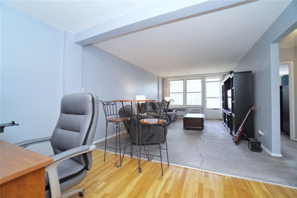 a living room with furniture a flat screen tv and a table