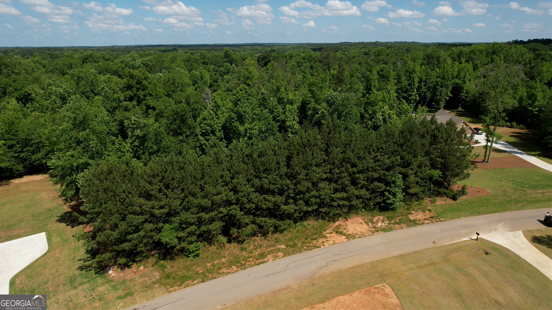 an aerial view of a houses with a yard