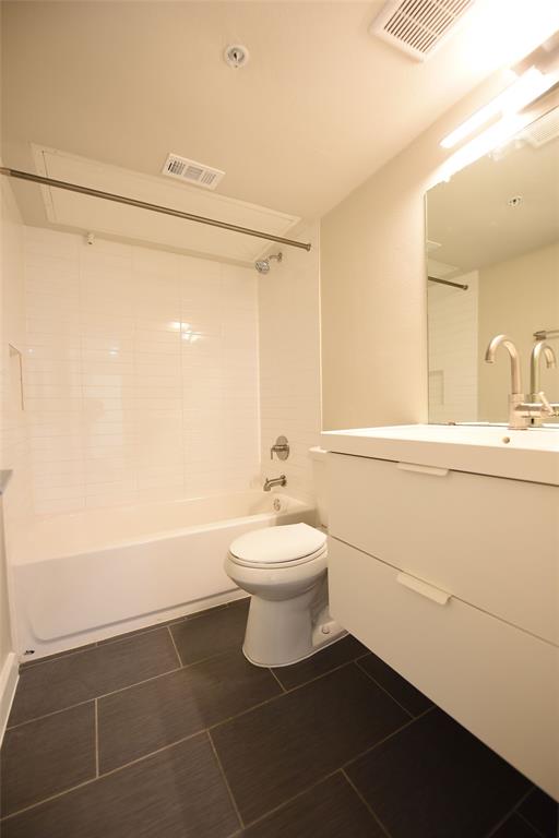 a bathroom with a sink mirror toilet and shower